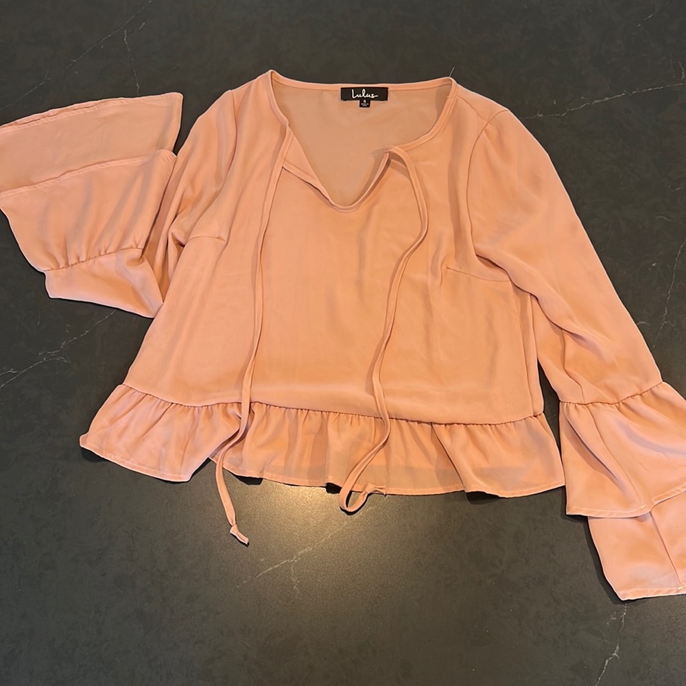 light pink cropped blouse with flowy sleeve detail